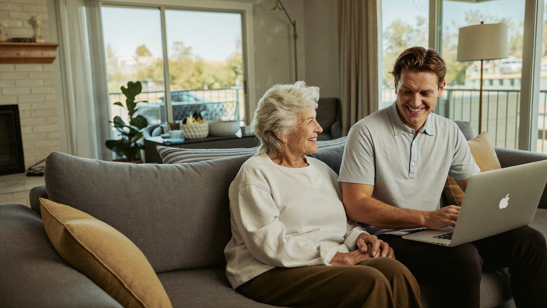 Young advisor going over Medicare options on a laptop with a woman in her seventies