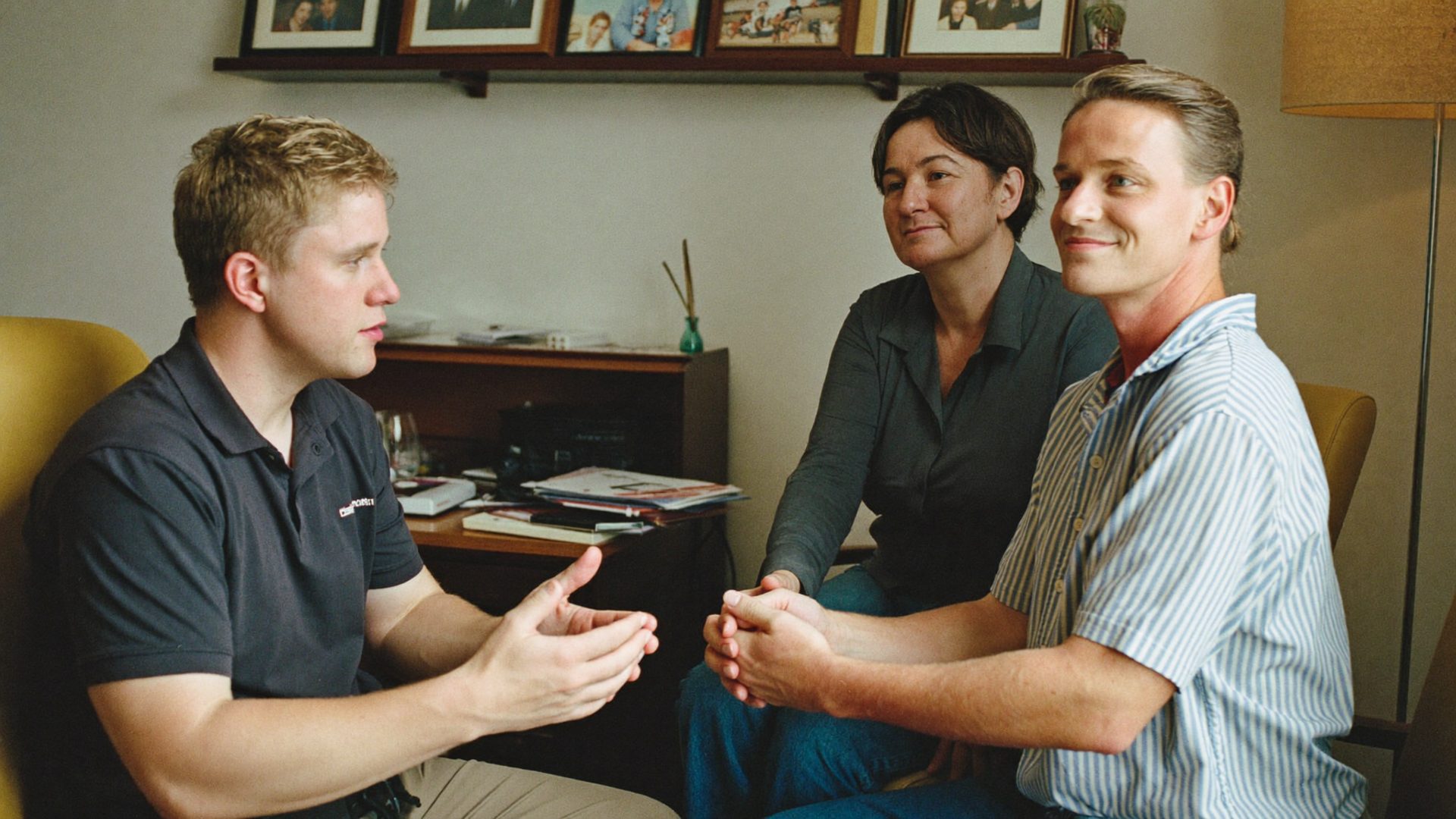 Advisor explaining life insurance to a couple in their home office